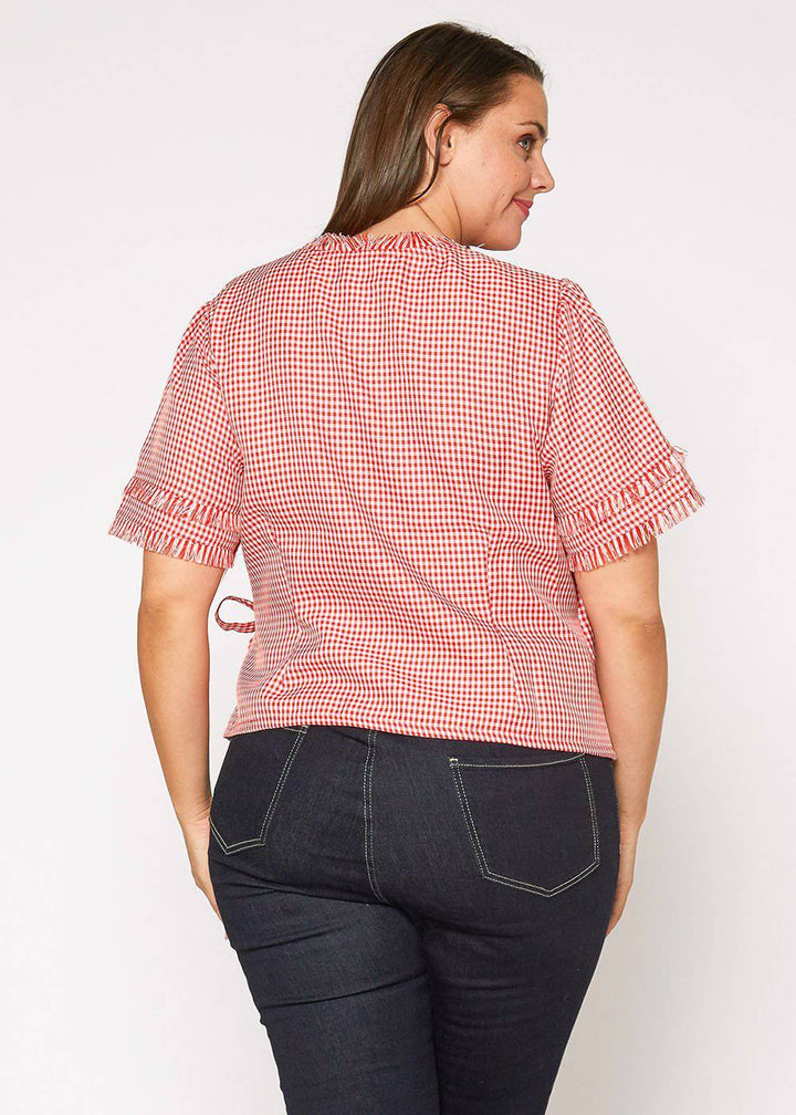 Plus Size Fringe Trim Gingham Wrap Blouse in Red Gingham by Shop at Konus