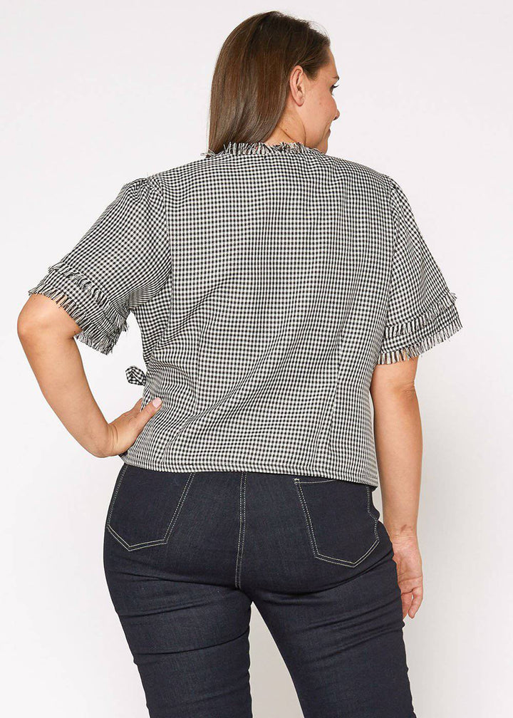 Plus Size Fringe Trim Gingham Wrap Blouse in Black Gingham by Shop at Konus